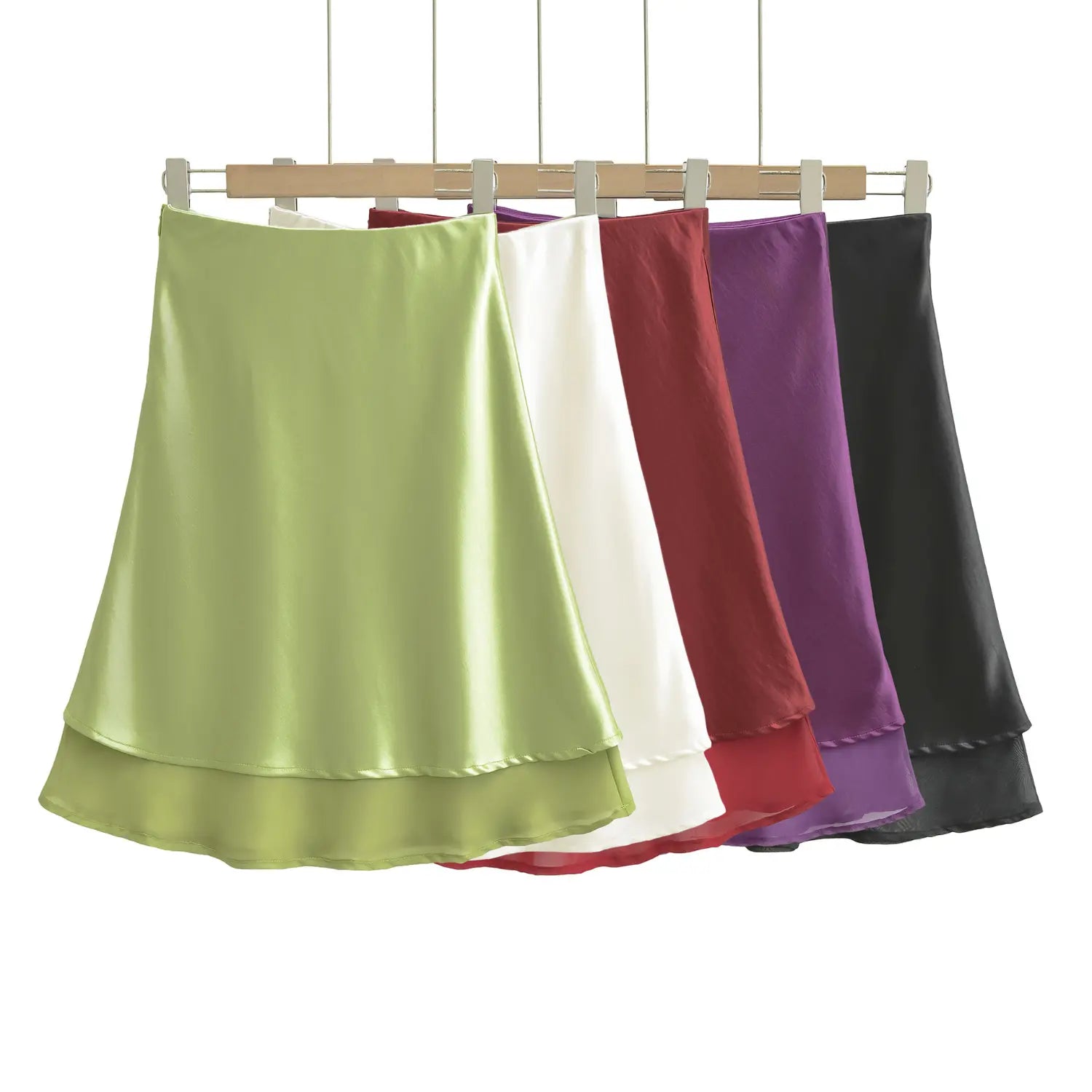 Five color satin layered skirts wooden clip hanger side-by-side display shot, full color range drape fabric staggered double hem silhouette comparison shot