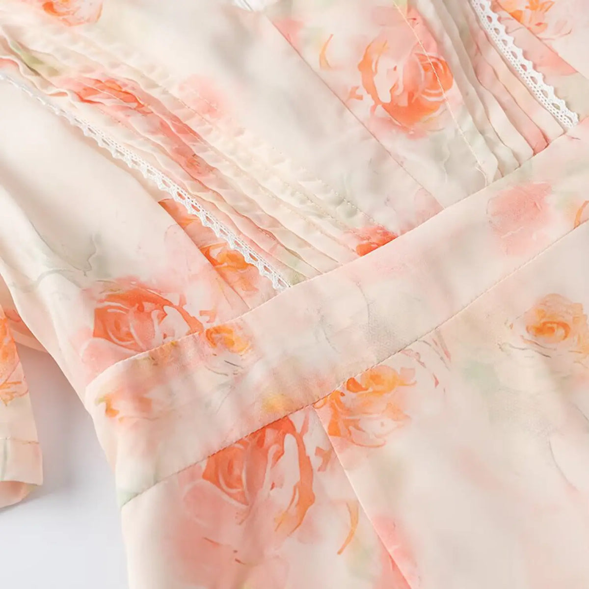 Close-up of bodice pintuck pleats and white lace trim detail