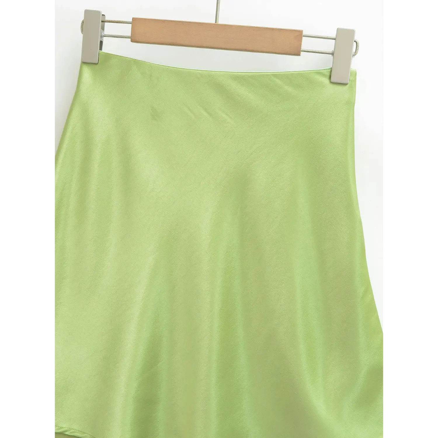 Full fabric shot of avocado green satin skirt, soft pearlescent satin drape with natural gentle wrinkles