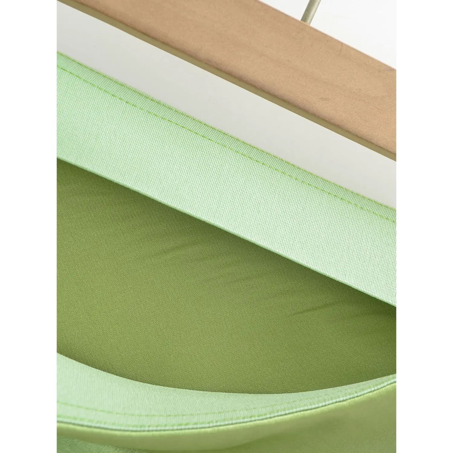 Double stitching close-up inside avocado green satin skirt waistband, reinforced binding and soft lining fabric