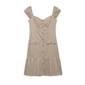 Hanger view of beige utility dress showing the full button placket, sweetheart neckline, and ruffled hem