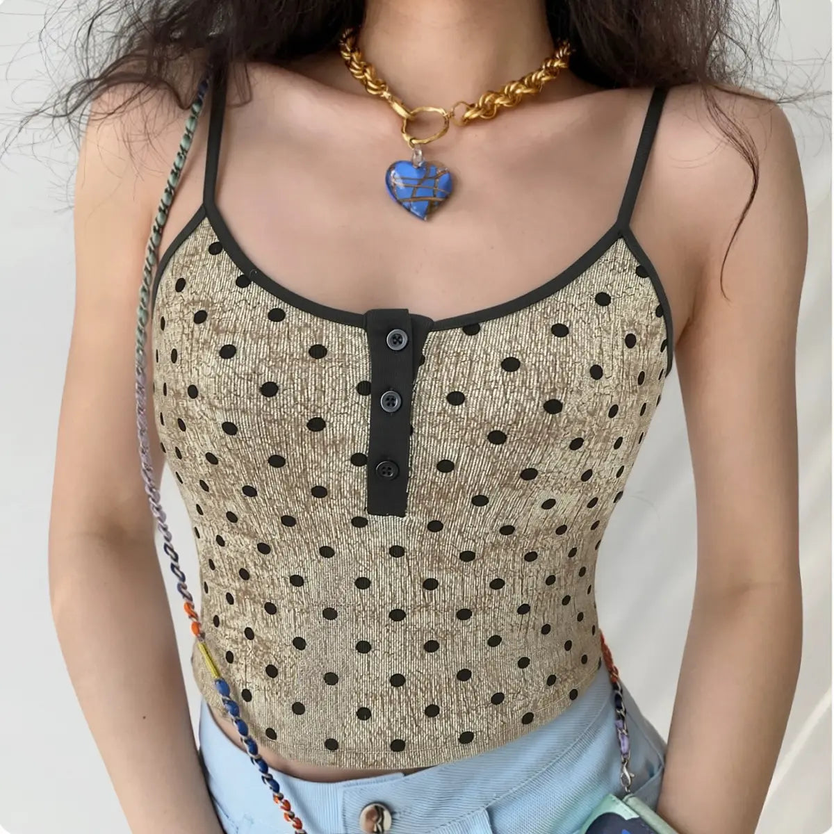 Model wearing beige polka dot Henley cami tank top