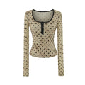 Front view of beige polka dot Henley long sleeve top