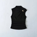 Front view of black tank top with gold metal ring and side ruching