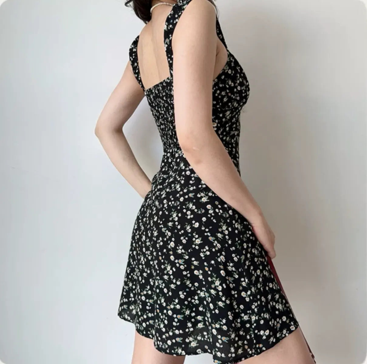 Back-side view of black floral mini dress