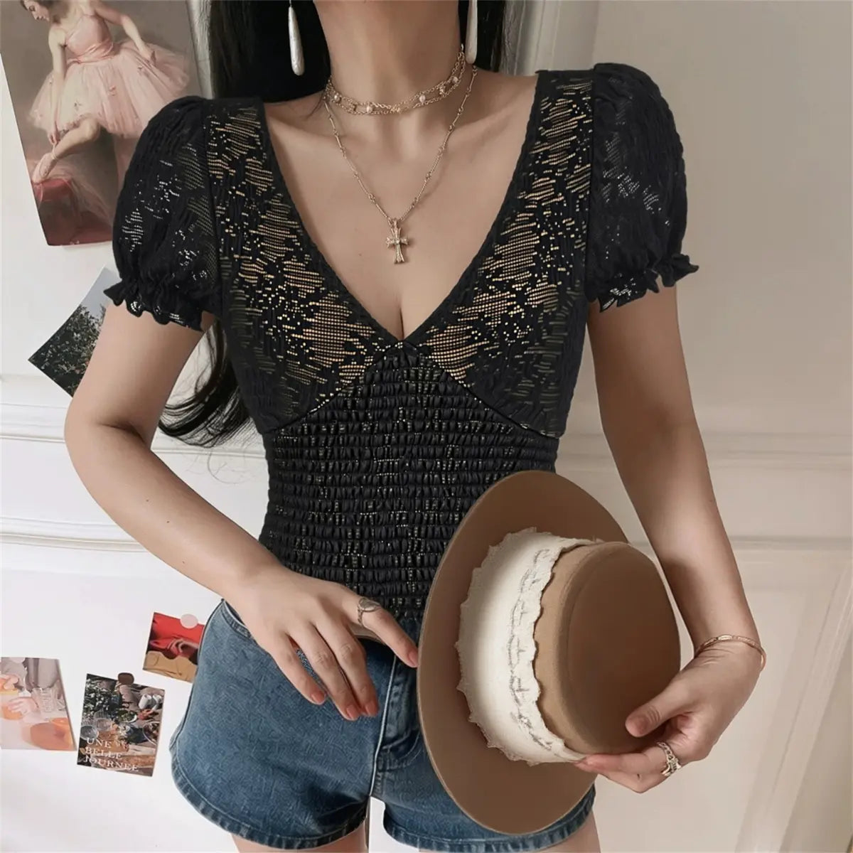 Model in black lace puff sleeve top, front view