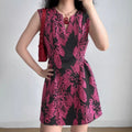 Model wearing black magenta floral sleeveless dress with keyhole neckline, fitted A-line mini dress