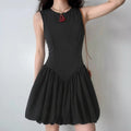 Model wearing black sleeveless mini dress with balloon hem and fitted bodice, elegant A-line party dress
