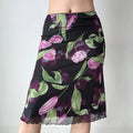 Close-up front view of model wearing black tulip print mesh midi skirt