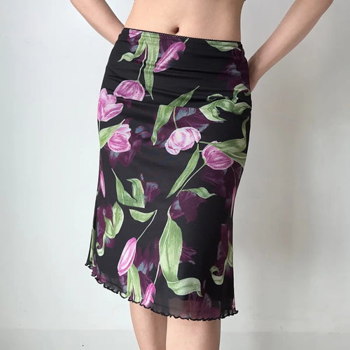Model wearing black tulip print mesh midi skirt, front view