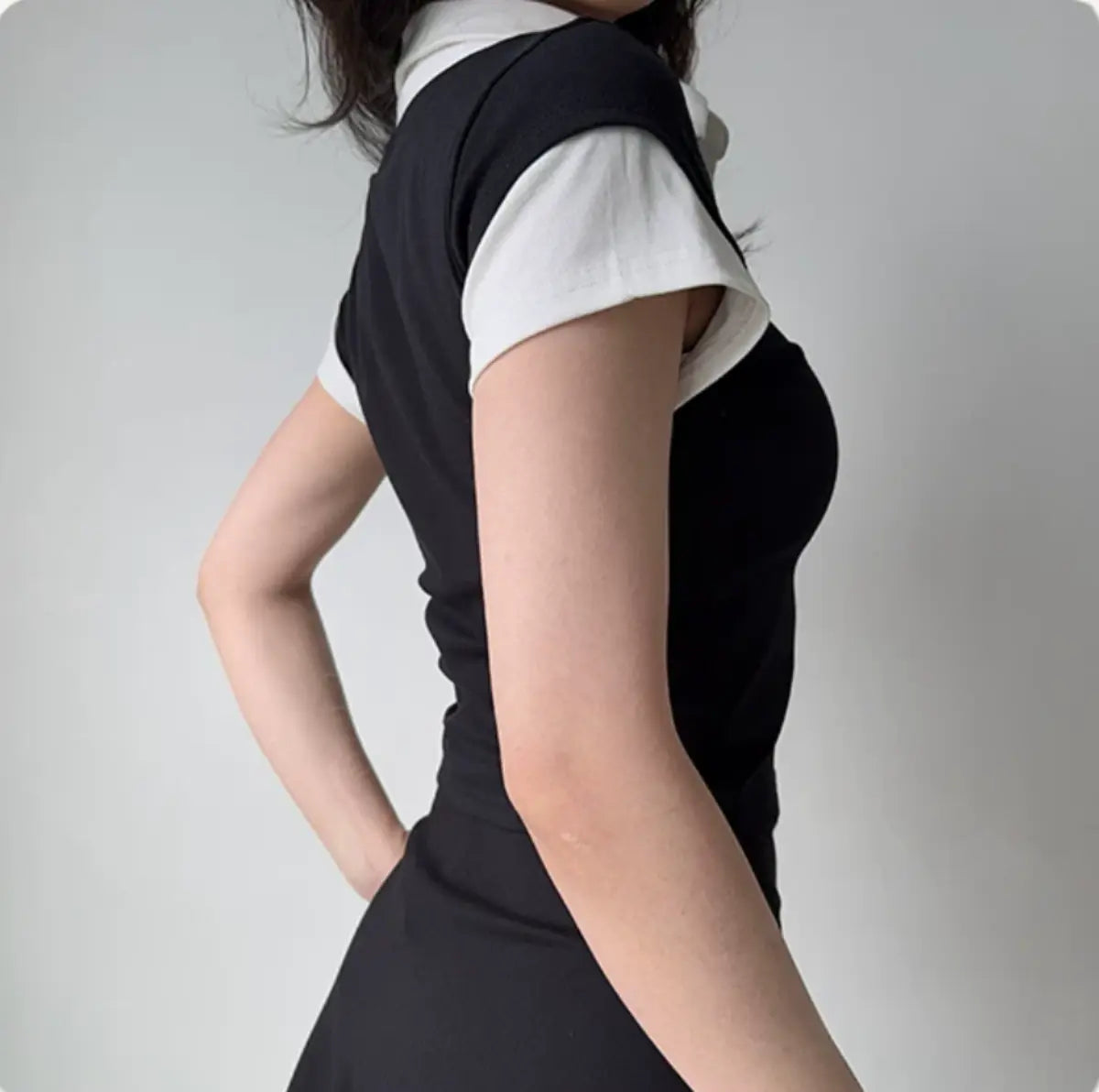 Back view of black faux two-piece dress showing the fitted silhouette and short sleeves