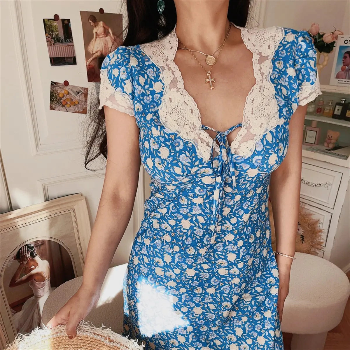 Close-up of blue ditsy floral lace-trim maxi dress on model