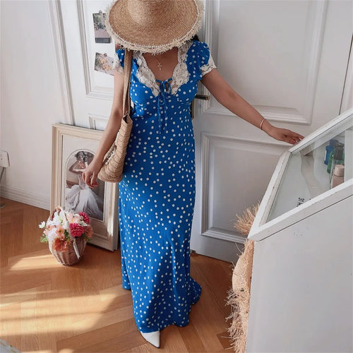 Model walking in blue ditsy print lace-trim maxi dress, front view
