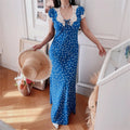 Front-side view of blue ditsy print lace-trim maxi dress on model