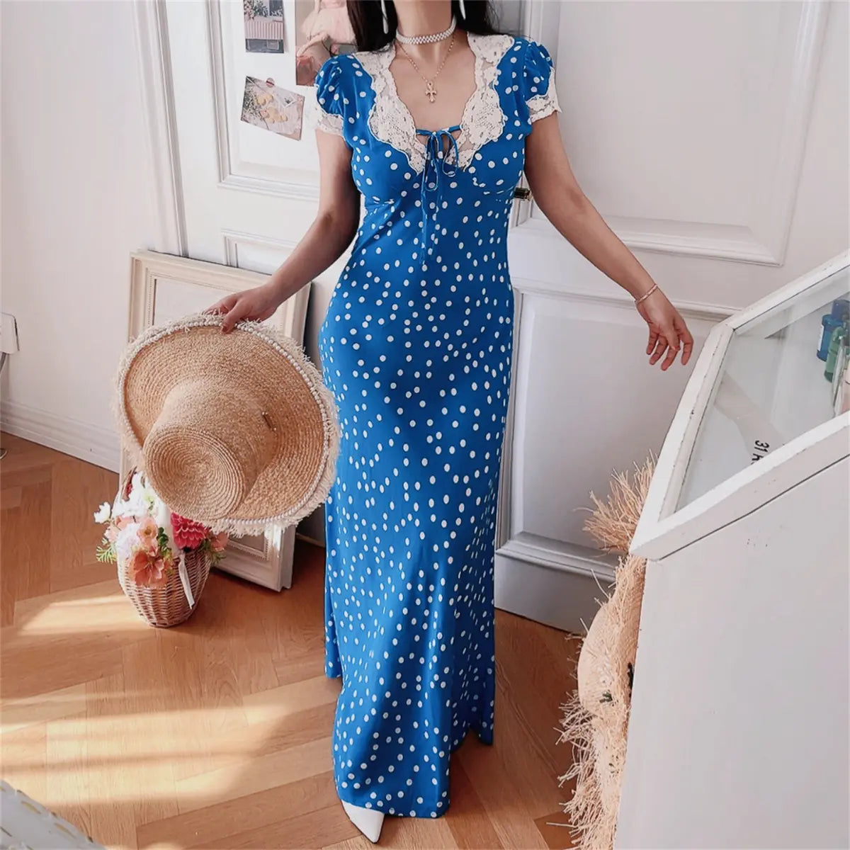 Front-side view of blue ditsy print lace-trim maxi dress on model