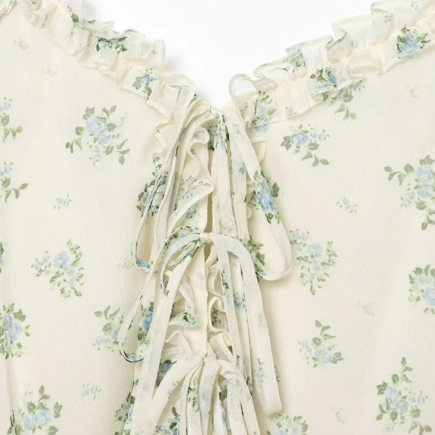 Front center lace-up macro shot, layered ruffle edge, self-fabric drawstring ties, neat serged stitching