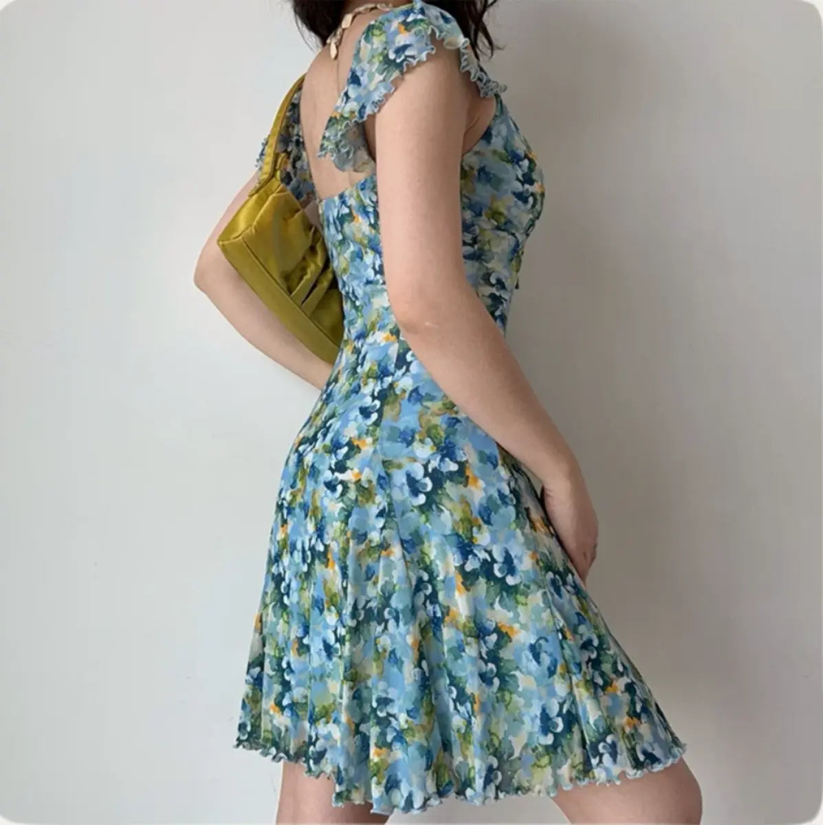 Back-side view of blue floral mini dress