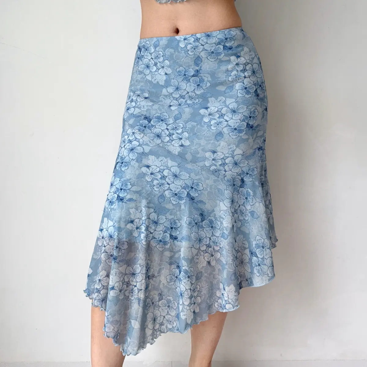Close-up of model wearing blue floral mesh midi skirt