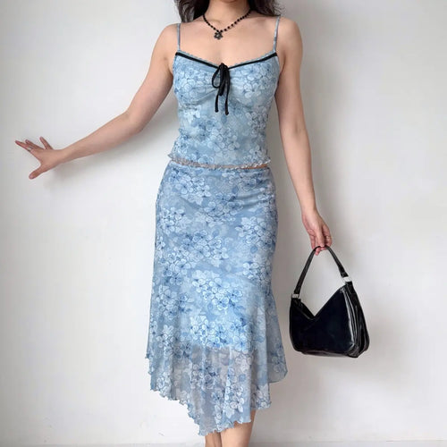 Model wearing blue floral mesh cami and midi skirt set, full front view