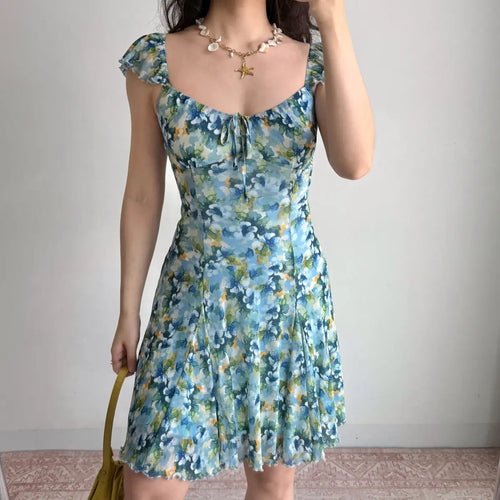 Model in blue floral off-shoulder mini dress, front view