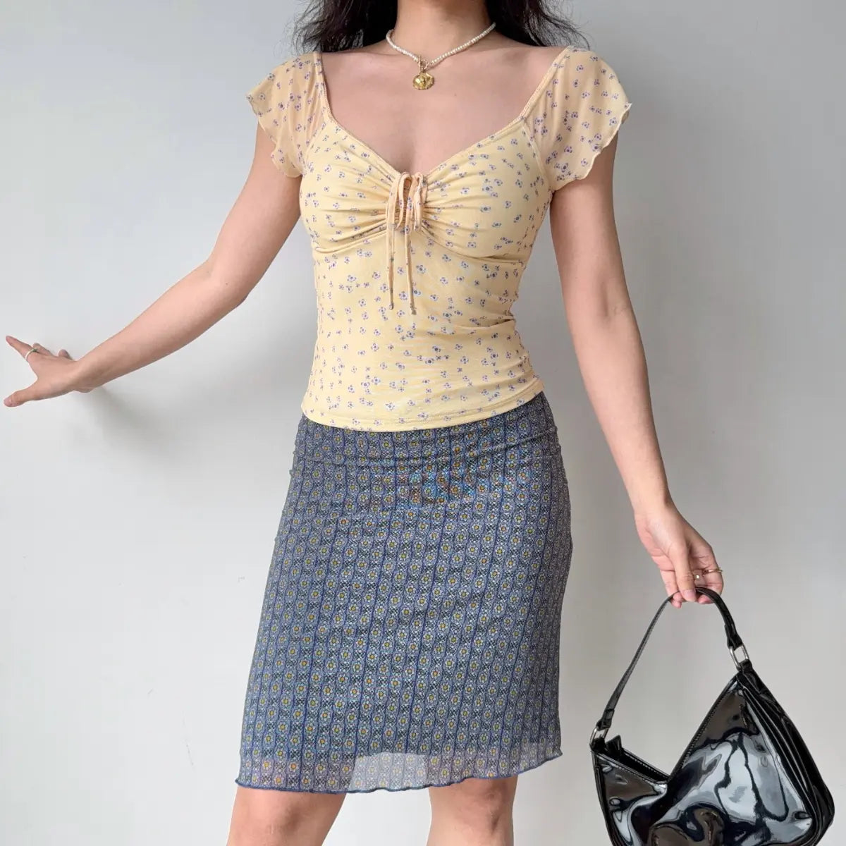 Blue floral mesh skirt styled with a yellow top