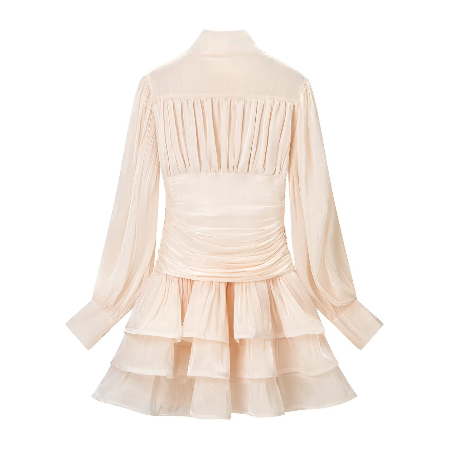 Back studio shot of blush pink tiered mini dress, highlighting the gathered elasticated back panel, sheer long sleeves, and full layered ruffle skirt