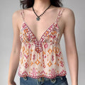 Model wearing boho-print cami top with double straps and peplum hem, flowy tribal-inspired spaghetti-strap top