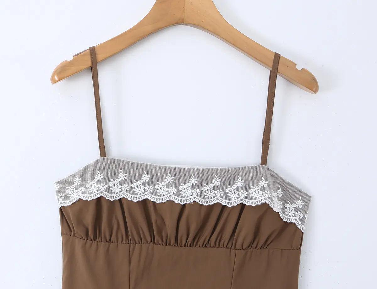 Close-up of the lace-trimmed bodice on the brown cami dress, hanging on a wooden hanger