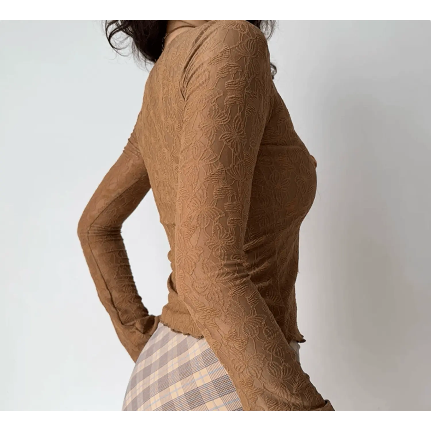 Side view of model wearing brown floral lace long sleeve fitted cropped top