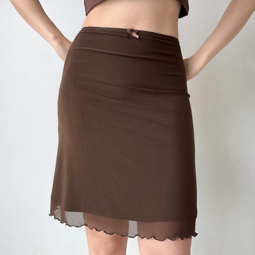Model wearing brown mesh midi skirt with bow detail, front view