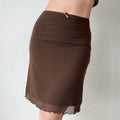 Model wearing brown mesh midi skirt, three-quarter view