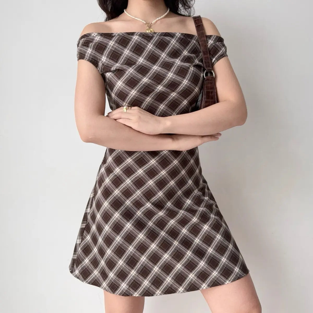 Brown plaid off-shoulder dress, crossed arms view