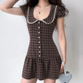 Model wearing brown plaid puff-sleeve mini dress with lace Peter Pan collar, vintage preppy outfit