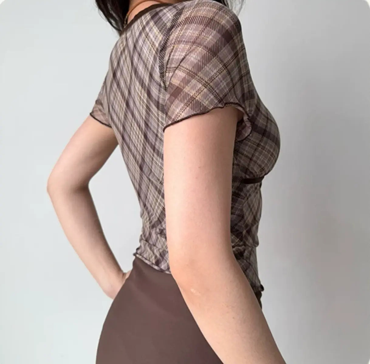 Back view of brown plaid mesh top with short sleeves and fitted waist