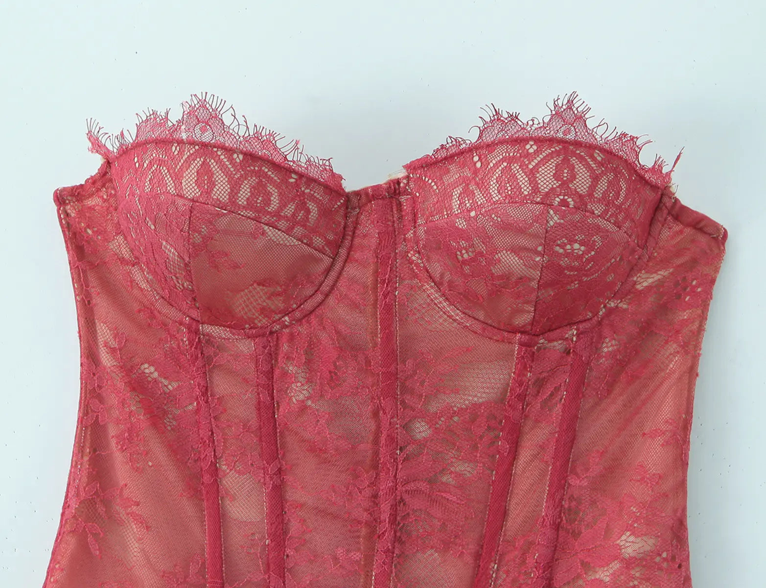 Close-up of lace trim and bustier detail on burgundy corset