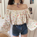 Dynamic front shot of floral off shoulder blouse, loose balloon long sleeves, soft wrinkled textured fabric