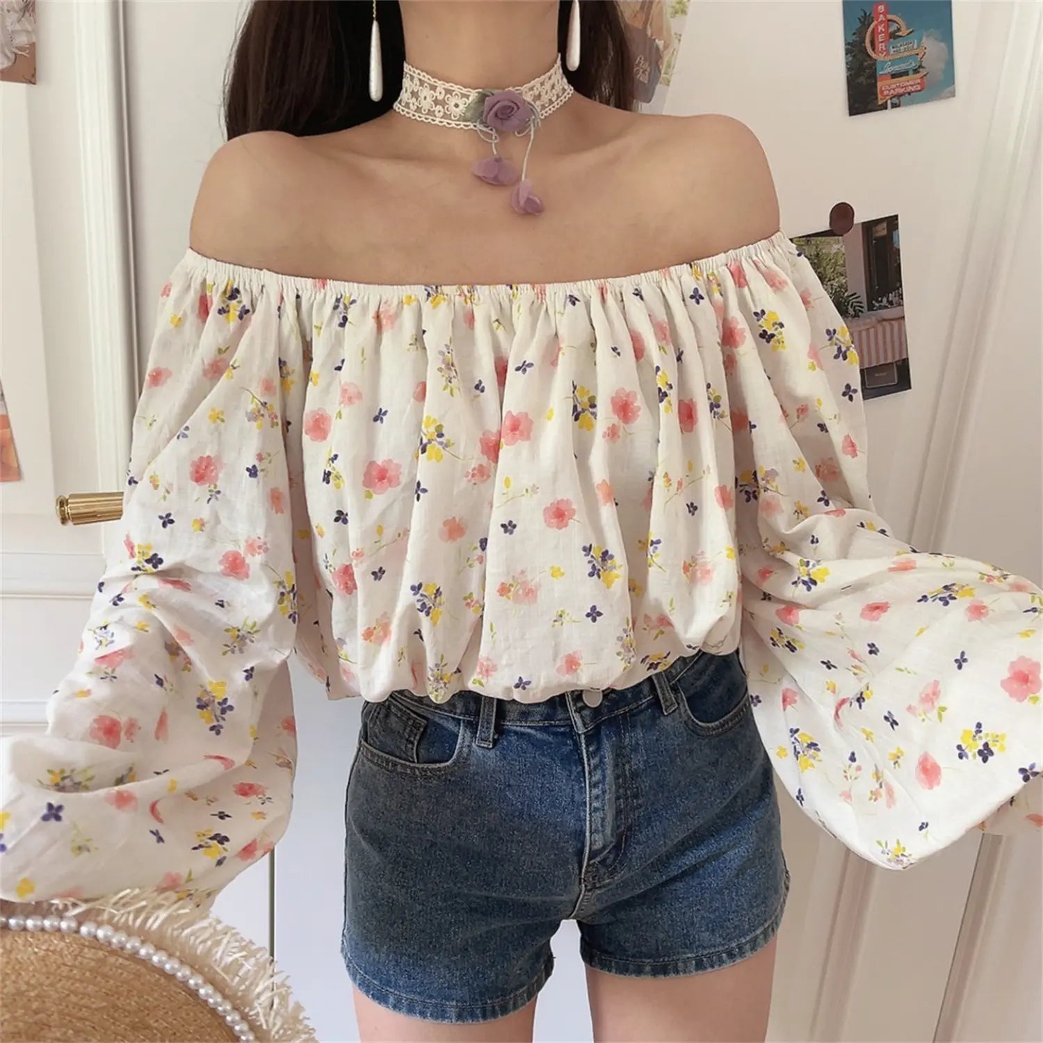 Dynamic front shot of floral off shoulder blouse, loose balloon long sleeves, soft wrinkled textured fabric