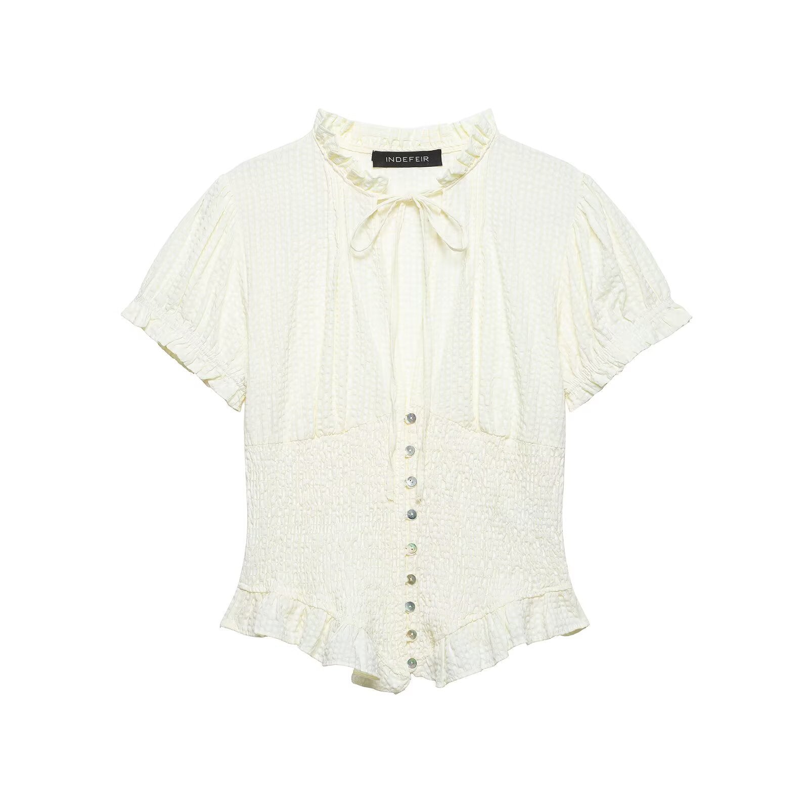 Front view of cream smocked tie-neck blouse