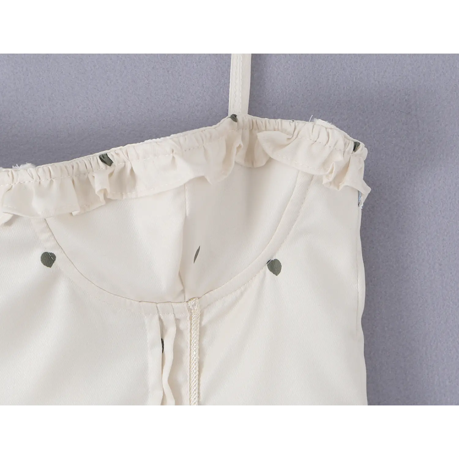 Close-up of ruffle frill neckline and structured bust stitching on cream cherry heart print corset cami