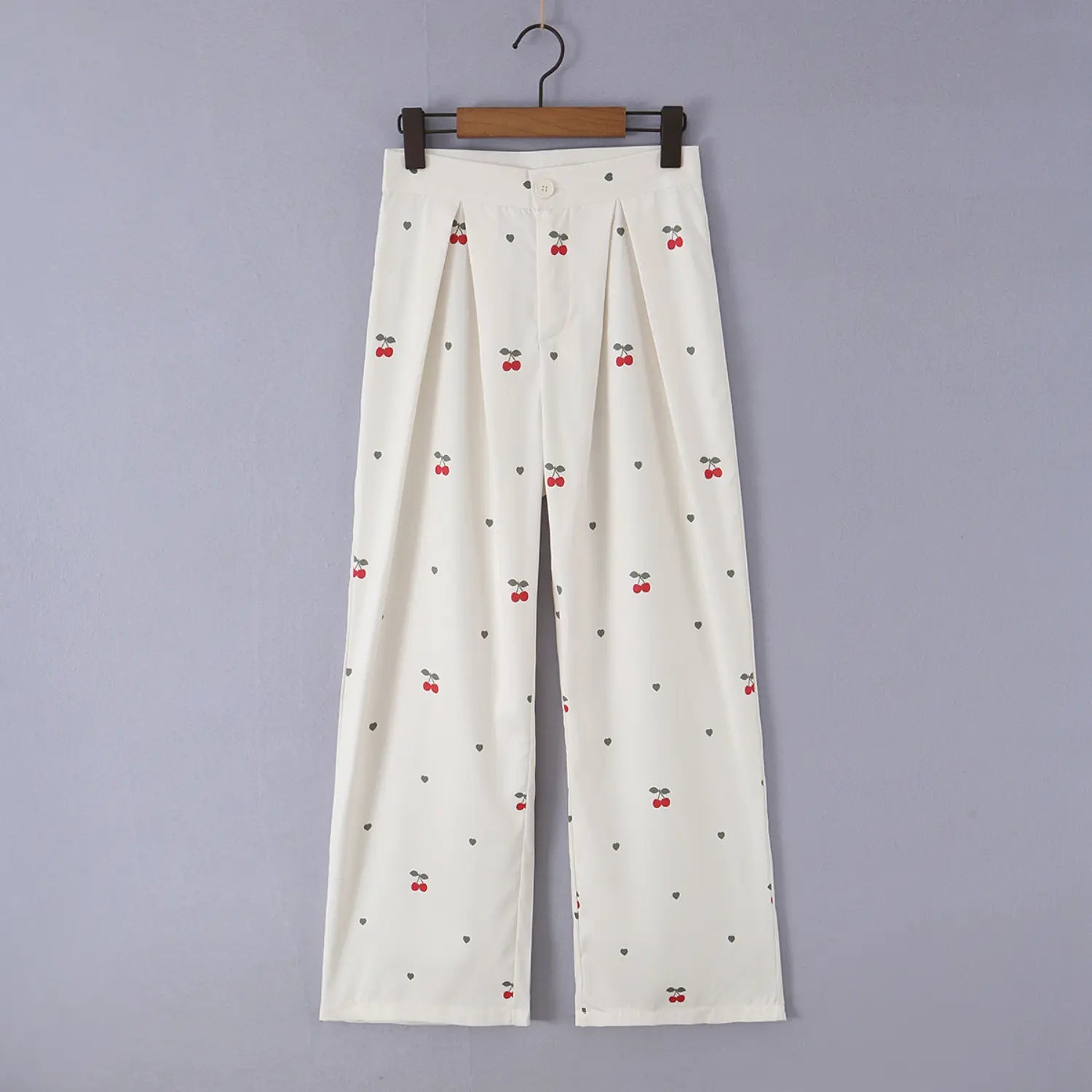 Hanging front real shot of cream cherry print pleated wide leg trousers, front waist pleats and full leg display