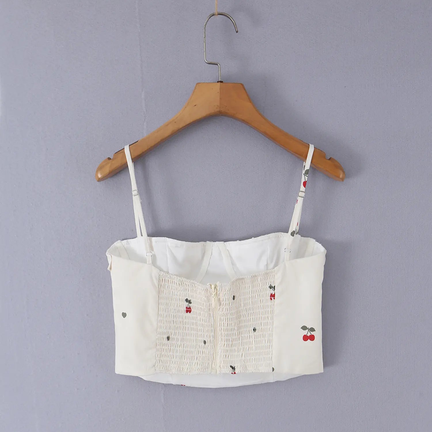 Hanging back detail shot of cream cherry print cami, showing stretch smocked fabric and back zipper craft