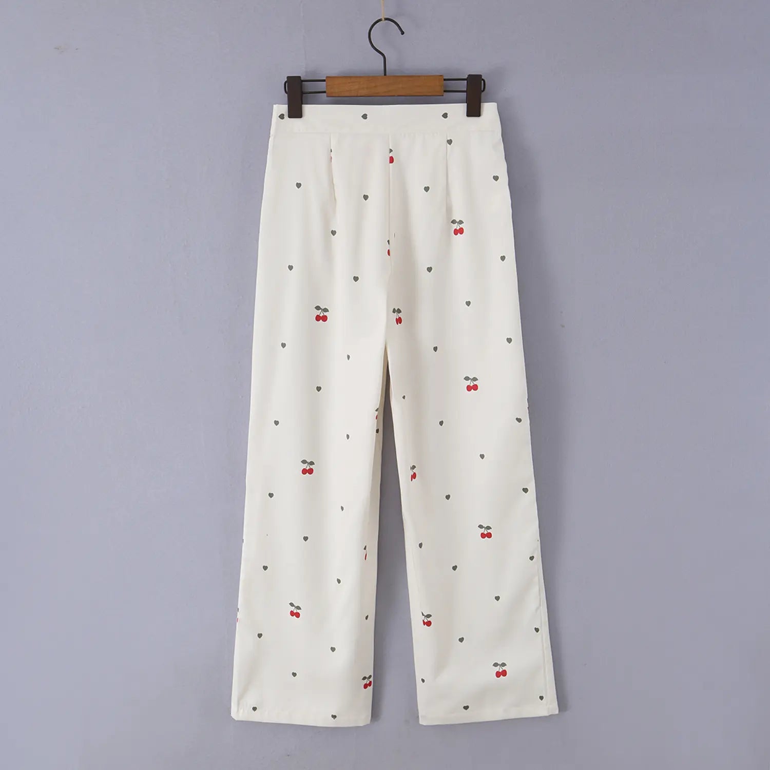 Hanging back detail photo of cream cherry print high waist wide leg pants, smooth loose fabric drape