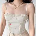 Model front wearing shot of cream ruffle neck corset cami with cherry & heart all over print, cropped fitted silhouette