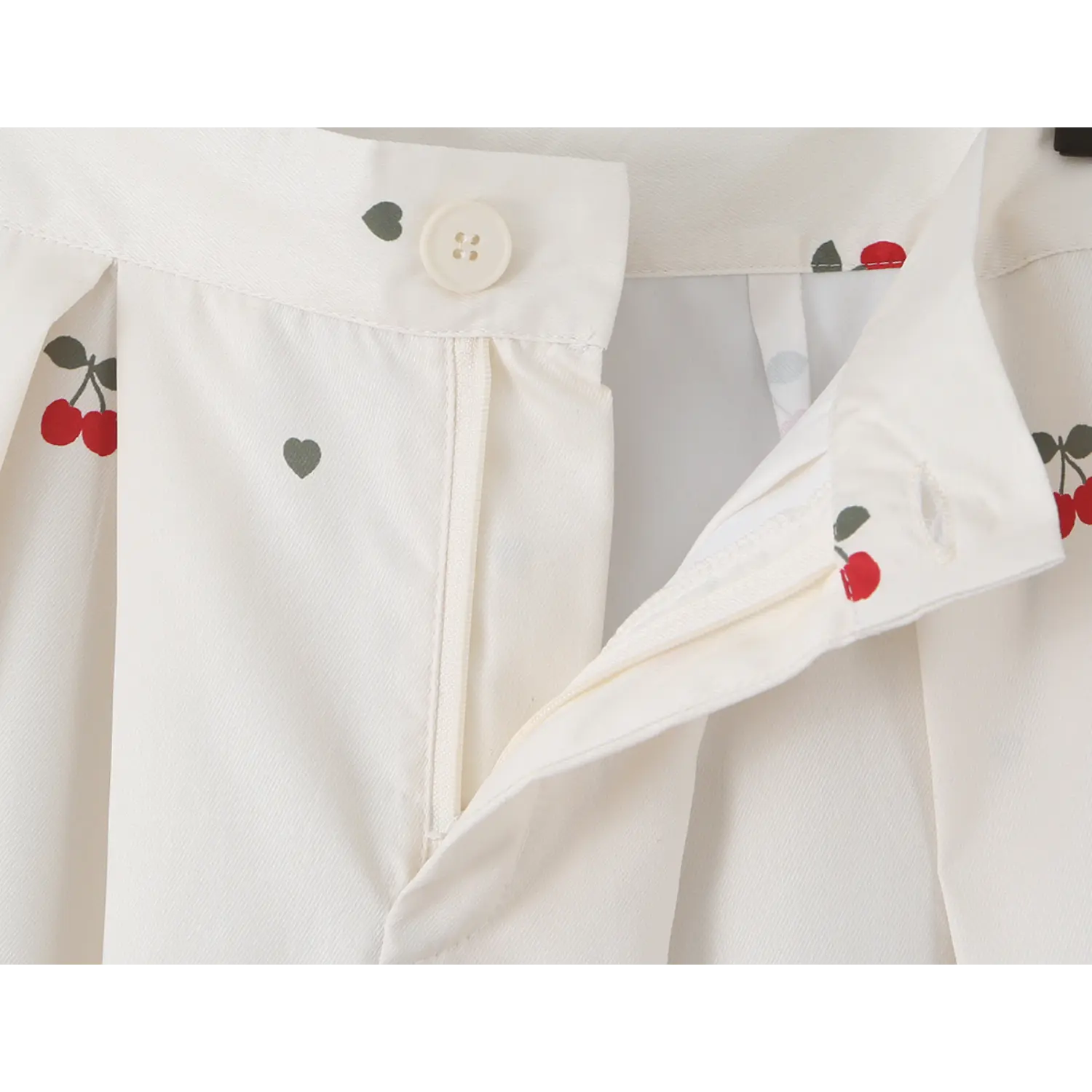 Open front fly close-up, showing matching cream four-hole button and smooth hidden zipper construction