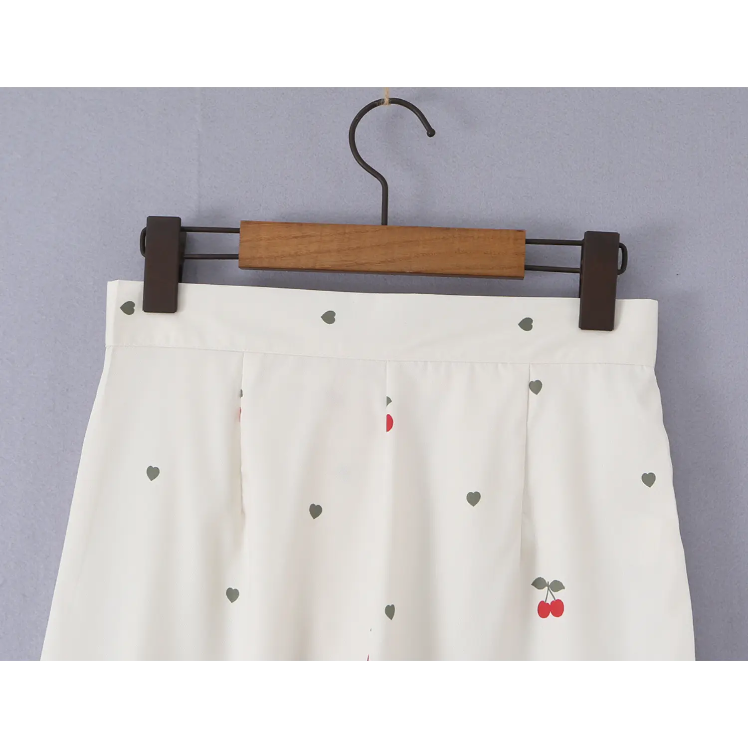 Hanging waistband overhead shot, back symmetrical pleats and all-over cherry heart print display