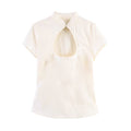 Hanger view of cream Chinese-style top showing the mandarin collar, keyhole cutout, and short sleeves
