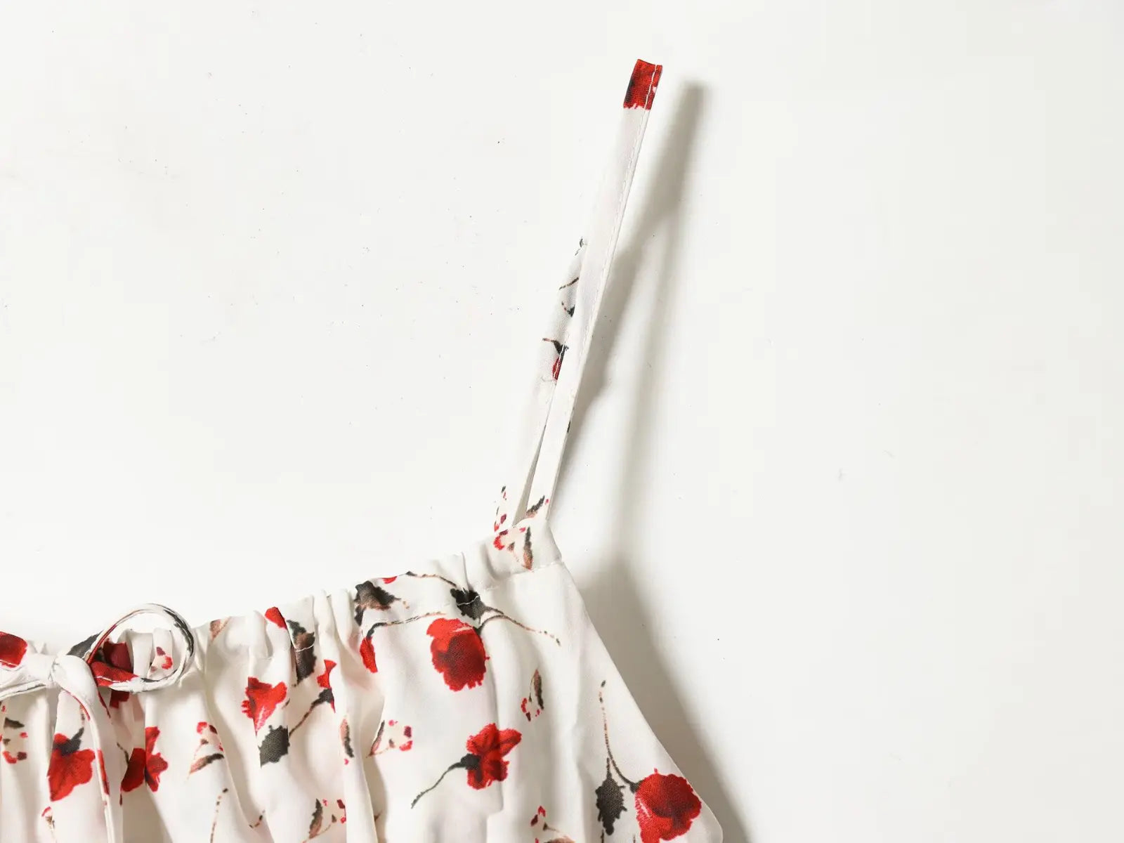 Cream cami midi dress with red roses, back view flat-lay on white background