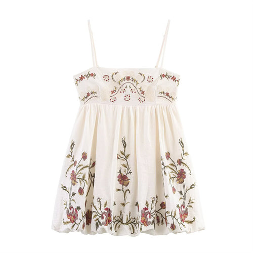 Front view of cream cami mini dress with intricate floral embroidery and flowy A-line skirt