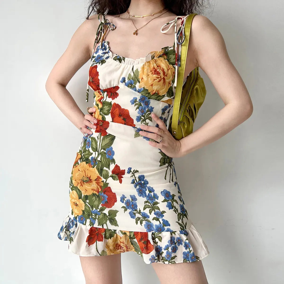 Front view of cream floral print cami dress with tie shoulder straps and fitted silhouette