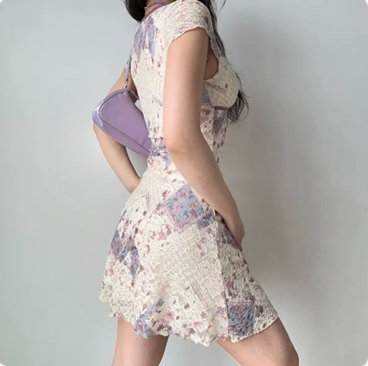 Back view of cream floral lace dress with short sleeves and flowy A-line hem